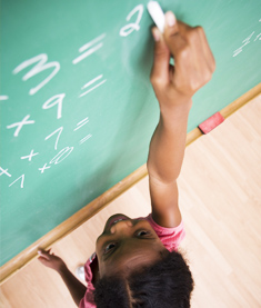 Student writing on chalkboard